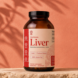 SHIFA Liver bottle in dappled sunlight against a terracotta wall
